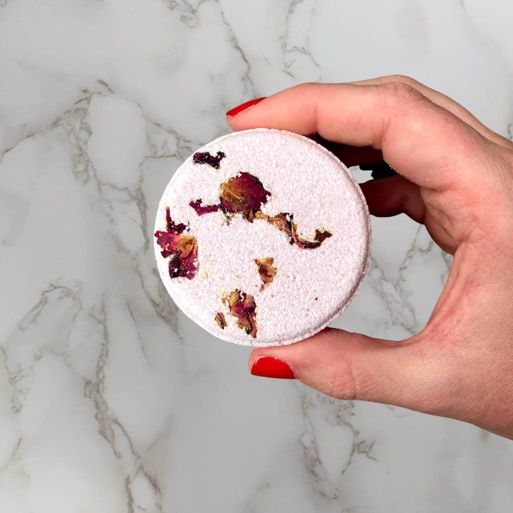 holding a shower steamer, flower infused shower steamer