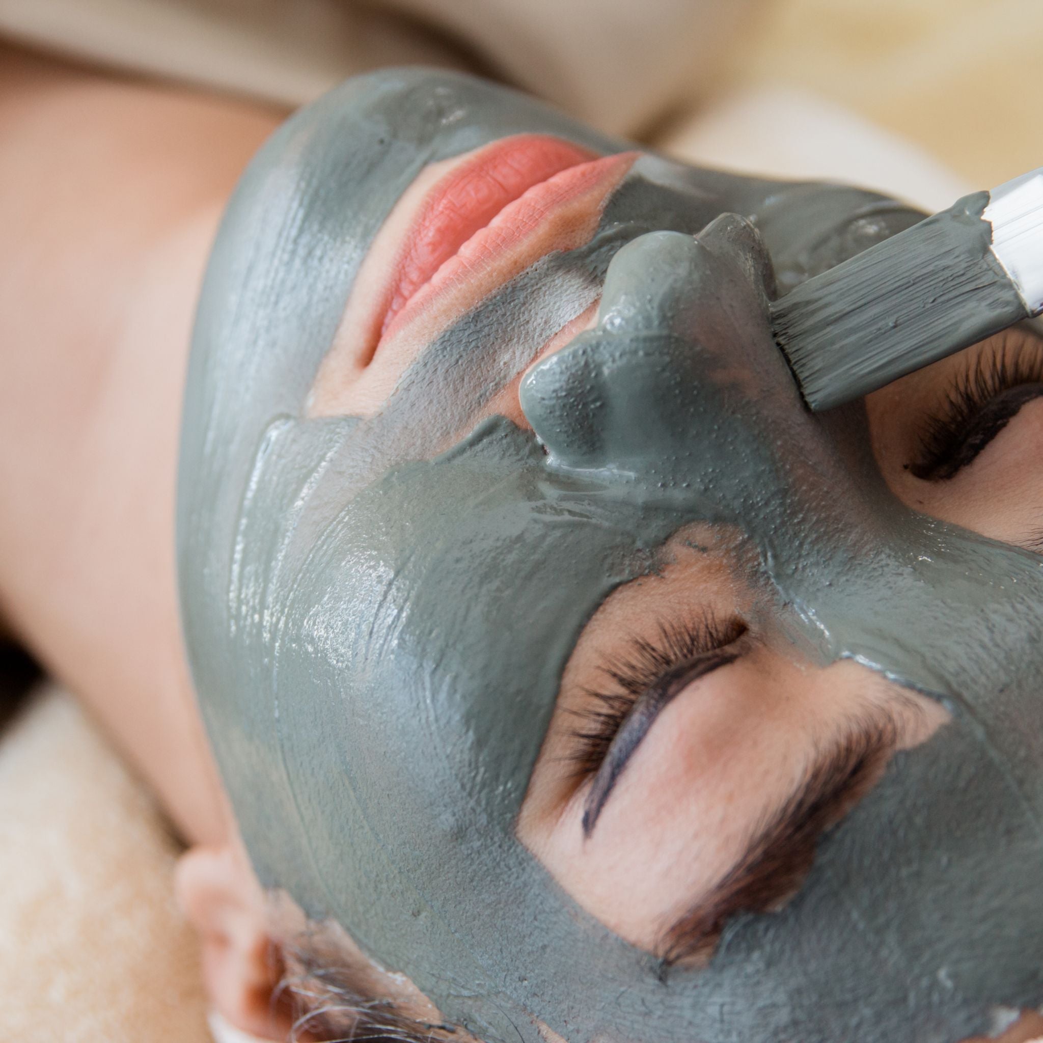 Woman using a Dead Sea mask as a form of self care
