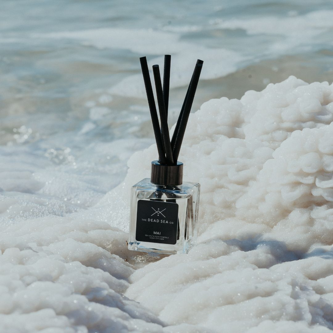 Reed diffuser sitting on Dead Sea salt at the Dead Sea