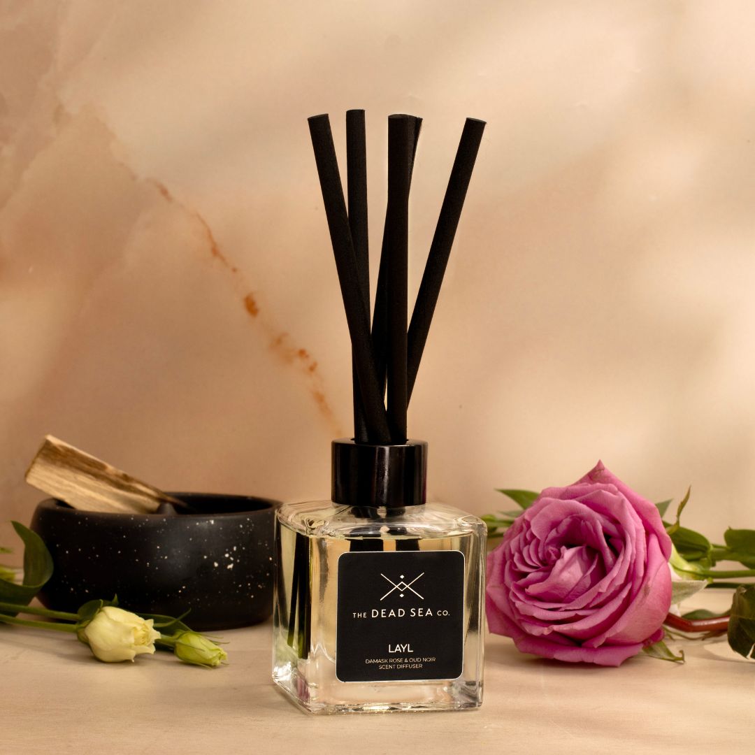 The Dead Sea Co. Damask Rose & Oud Noir Reed Diffuser elegantly placed in a luxurious setting, with rich floral notes and deep woody accents.