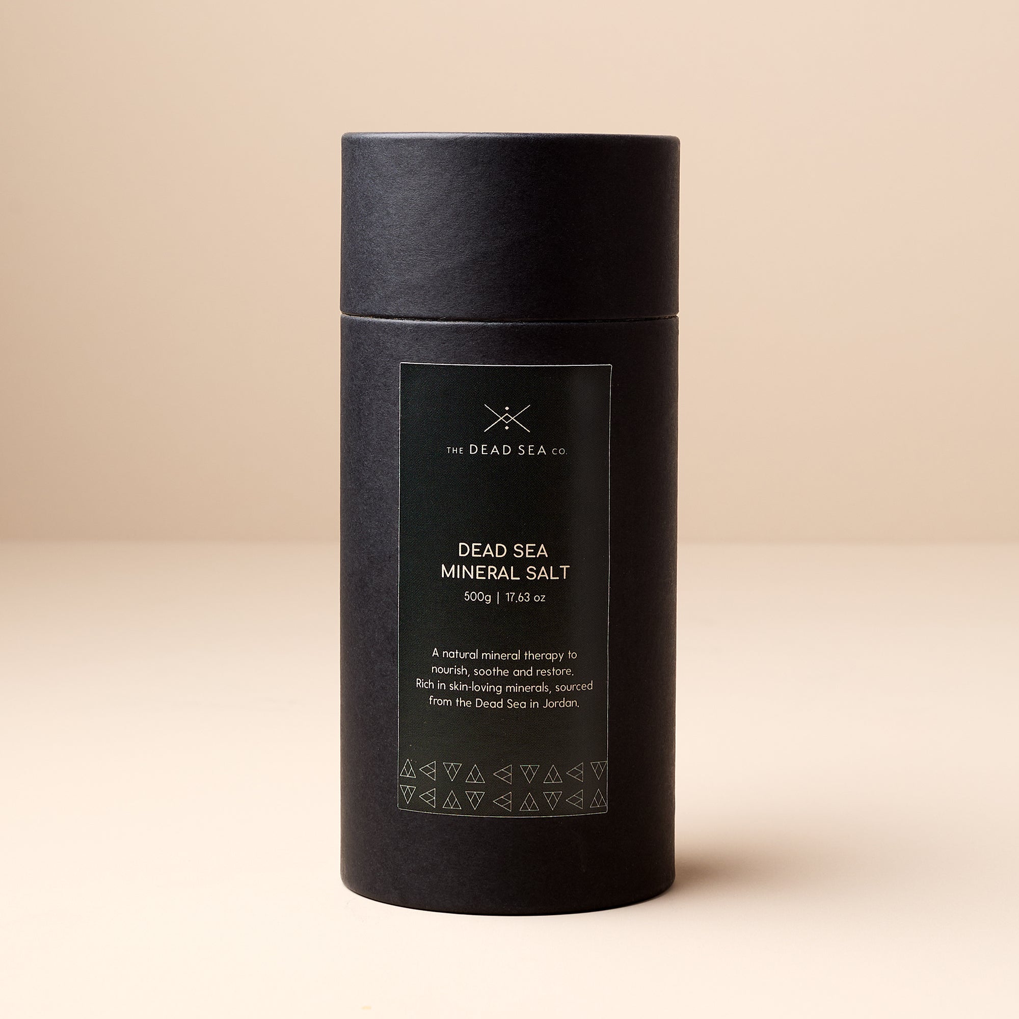 Front view of The Dead Sea Co. Dead Sea Mineral Salt in a premium black tube, labelled with product name and benefits.