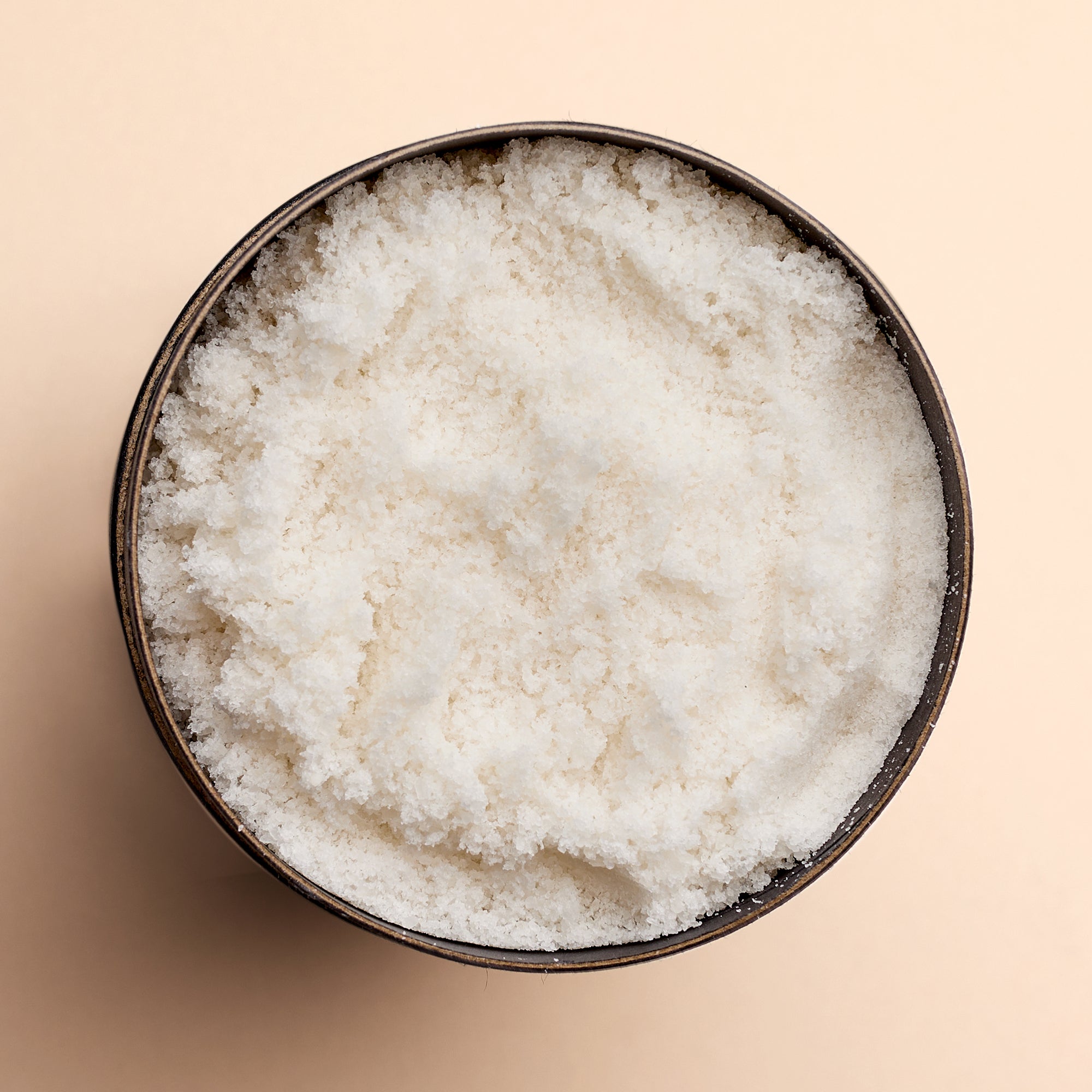Top-down view of open Dead Sea Co. Mineral Salt container, pure mineral-rich salt for natural skincare and bath rituals.