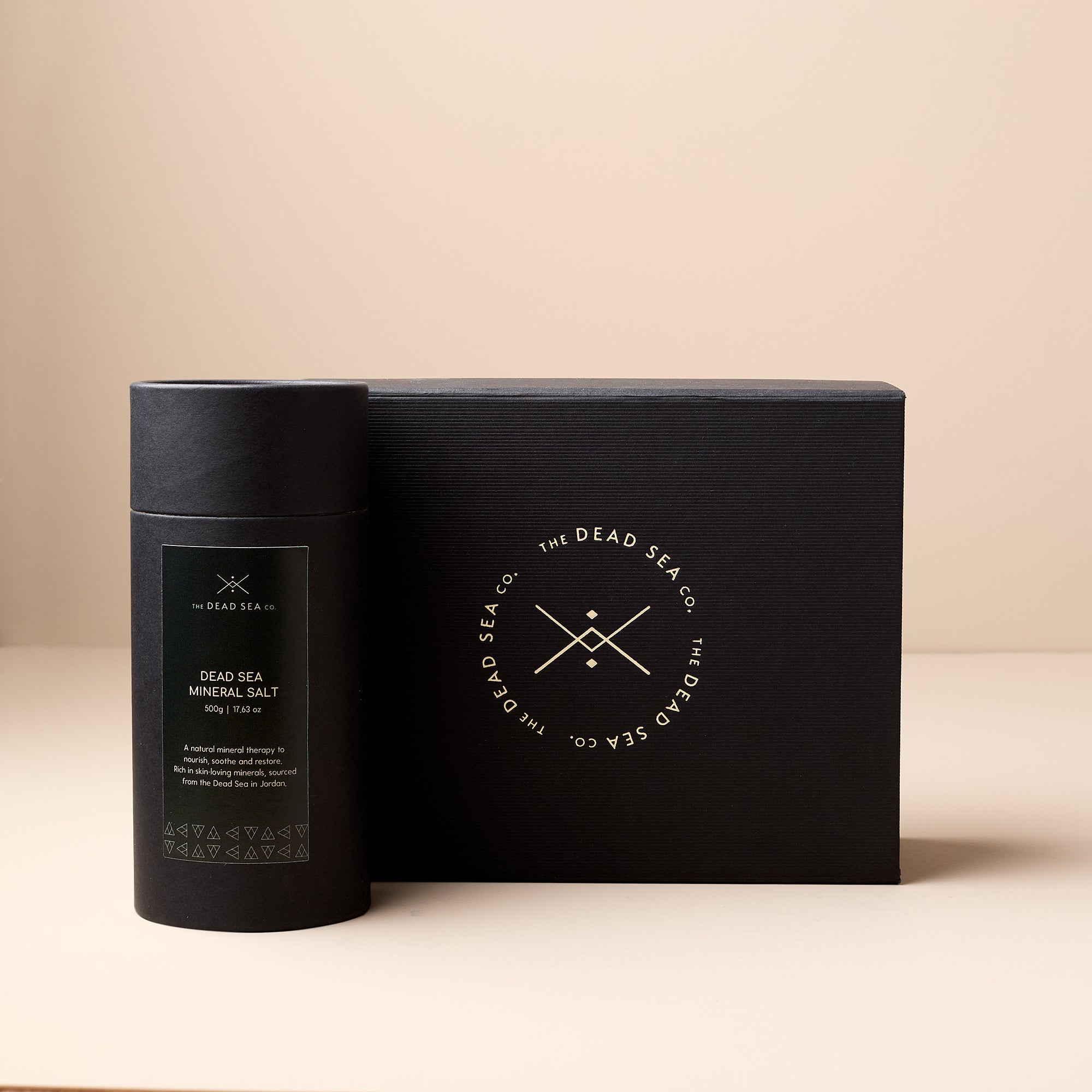 The Dead Sea Co. Dead Sea Mineral Salt with accompanying branded gift box, featuring sleek black design and gold foil logo.