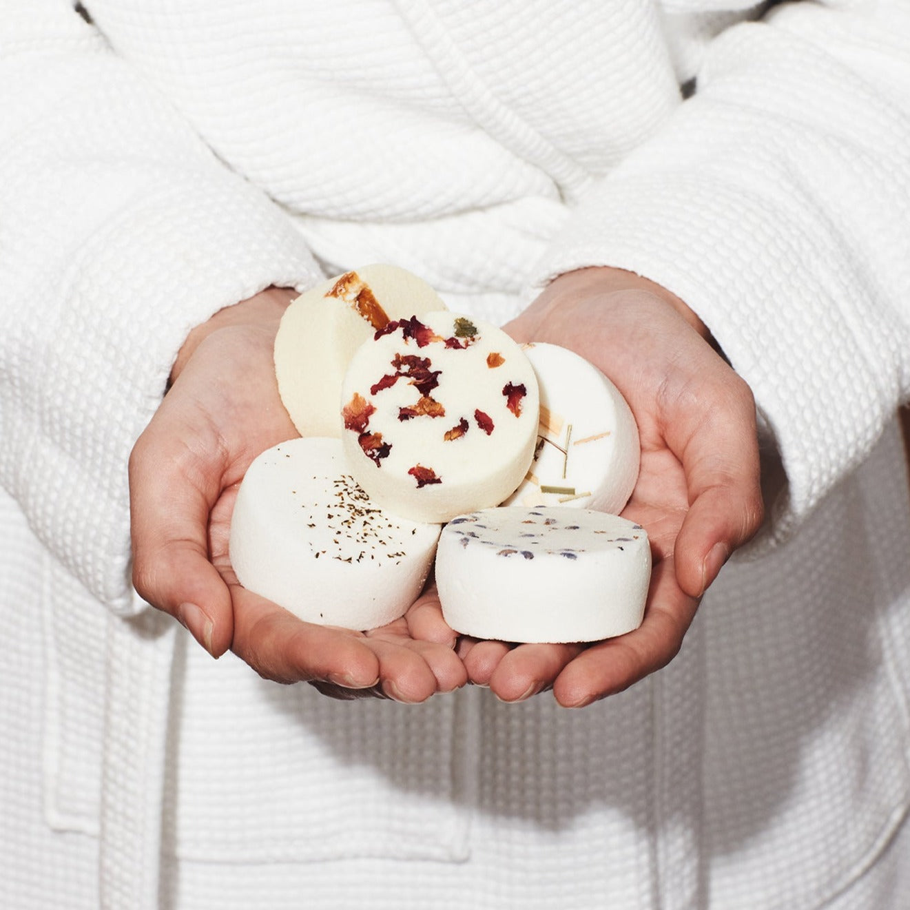 Woman holding mixed box of aromatherapy shower steamers